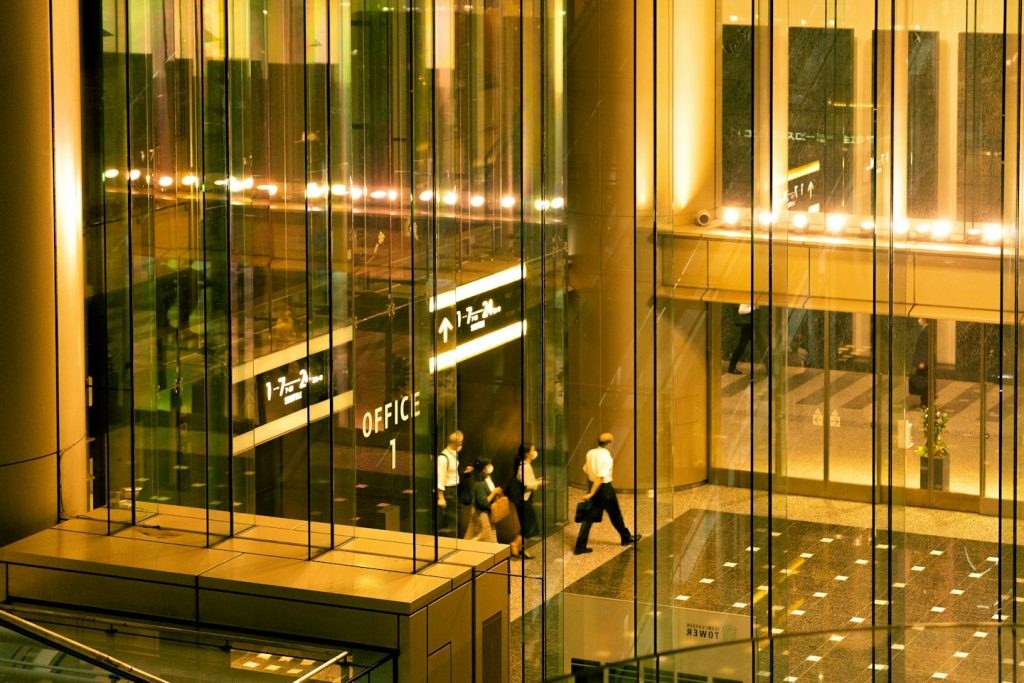 Glass office building interior glowing at night