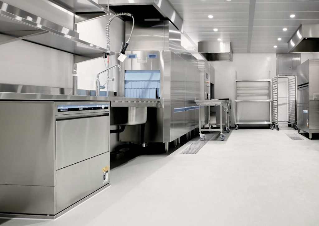 Commercial kitchen with stainless steel appliances and utility carts
