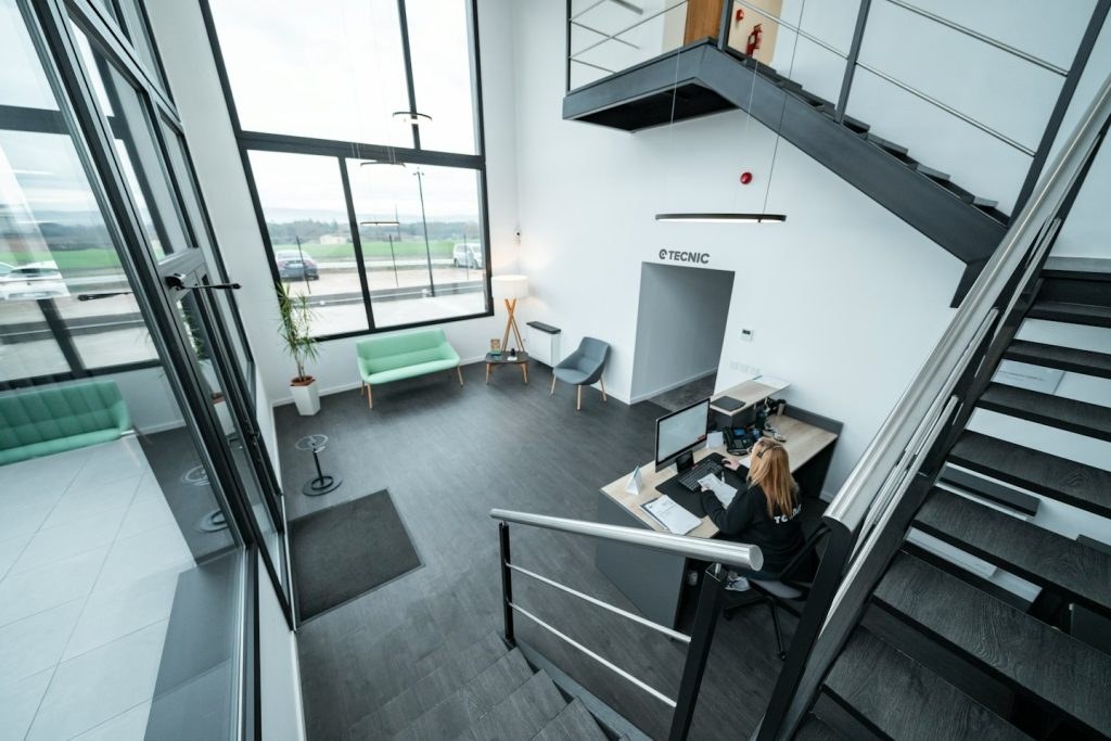 Receptionist working at a computer in a modern office lobby